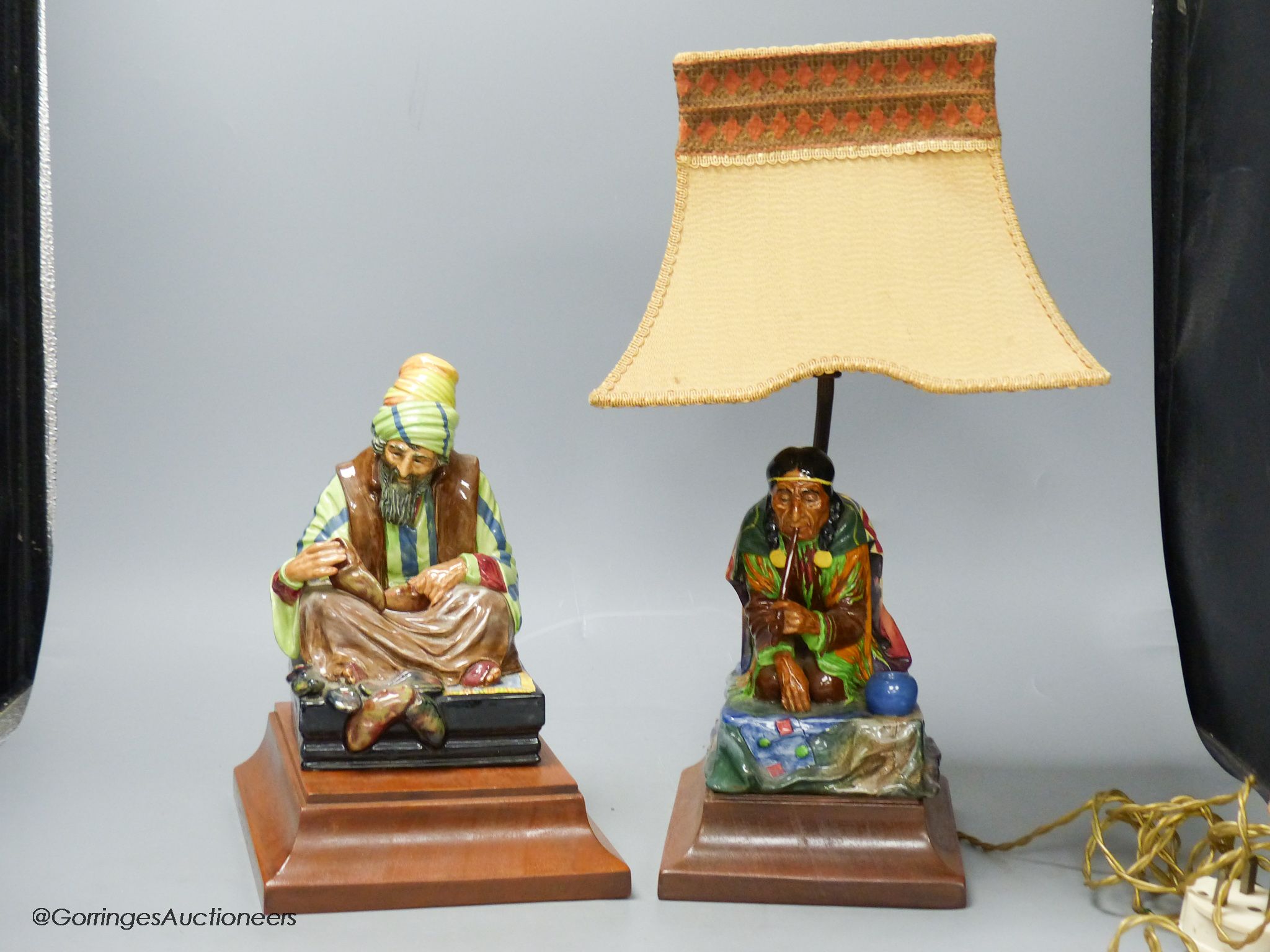 A Charles Noke for Royal Doulton, 'Cobbler', on wooden plinth and a similar figure of 'Calumet' (2)